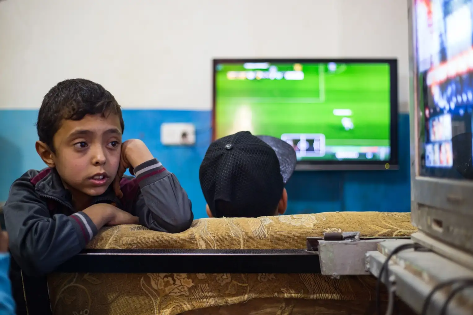 A young Palestinian joins his friends at the Sony Playstation shop