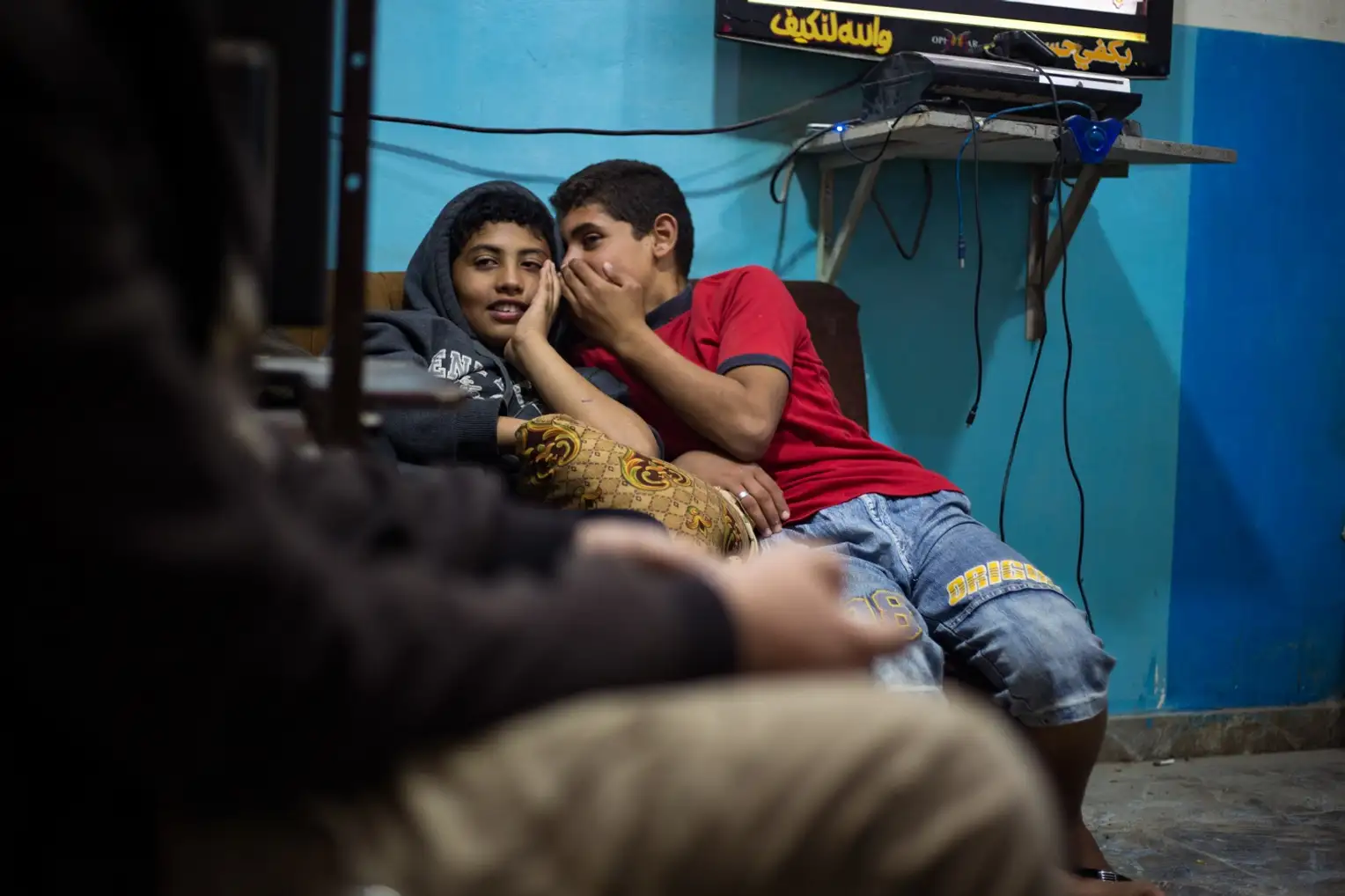 Children watch as their grandfather prepares for daily prayers